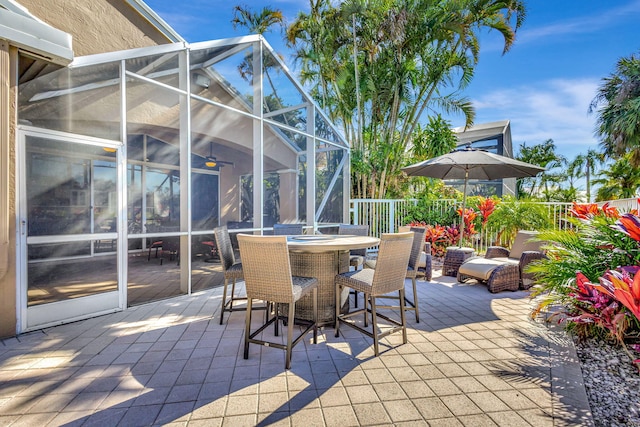 view of patio featuring a lanai