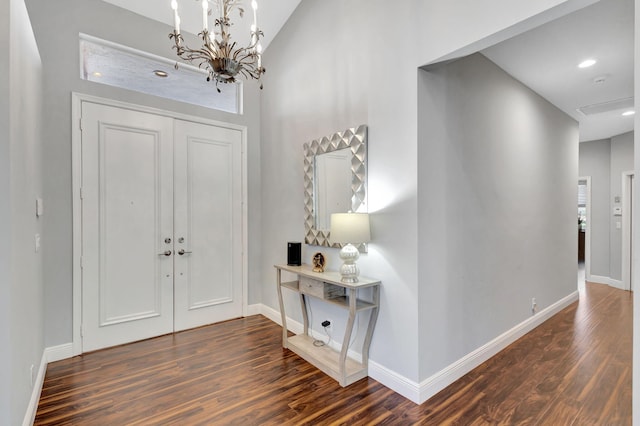 entrance foyer with dark hardwood / wood-style flooring and a chandelier