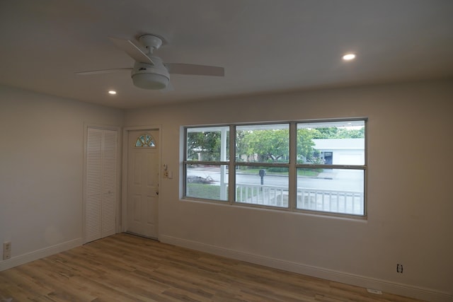 empty room with wood-type flooring and ceiling fan