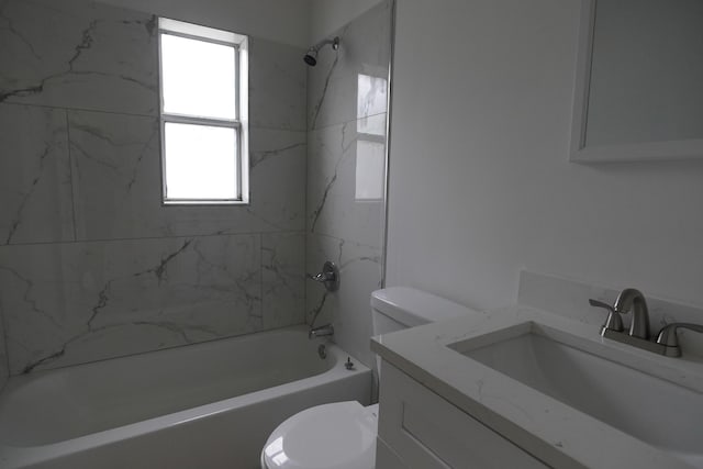 full bathroom with vanity, toilet, and tiled shower / bath combo