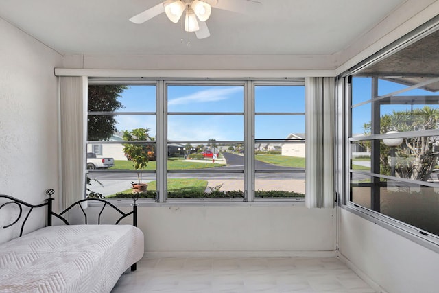 sunroom / solarium featuring ceiling fan