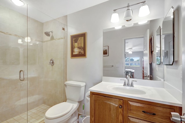 bathroom with vanity, toilet, and a shower with door