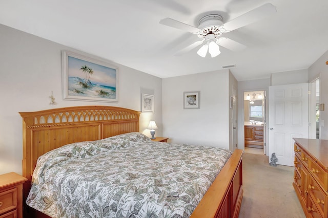 carpeted bedroom featuring ceiling fan, sink, and ensuite bath