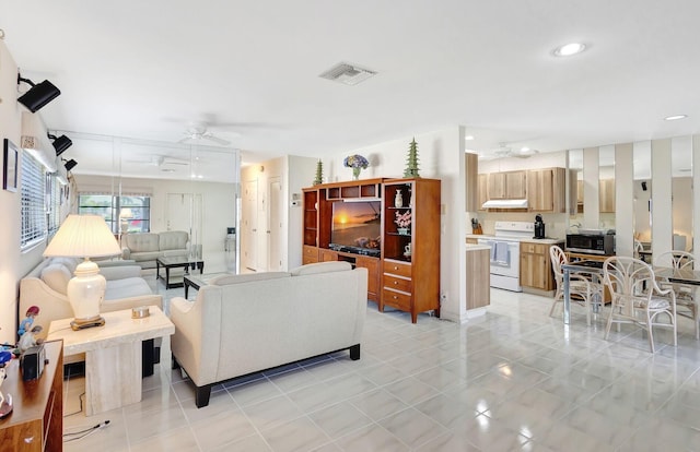 tiled living room with ceiling fan