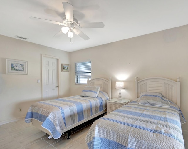 tiled bedroom featuring ceiling fan