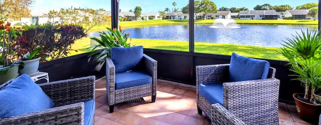 sunroom featuring plenty of natural light and a water view