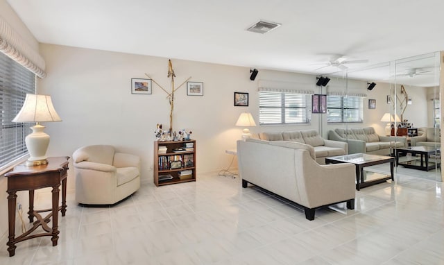 tiled living room featuring ceiling fan