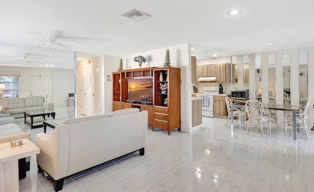 living room with light tile patterned floors and ceiling fan