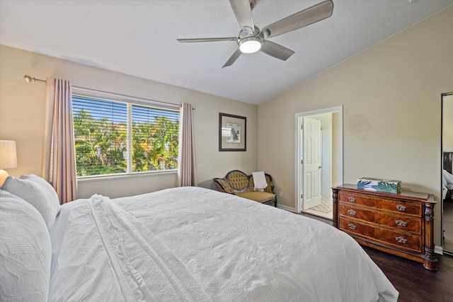 bedroom with ceiling fan, baseboards, lofted ceiling, and dark wood finished floors