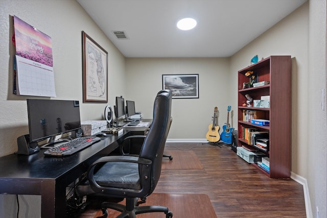 office space with visible vents, baseboards, and dark wood-style flooring