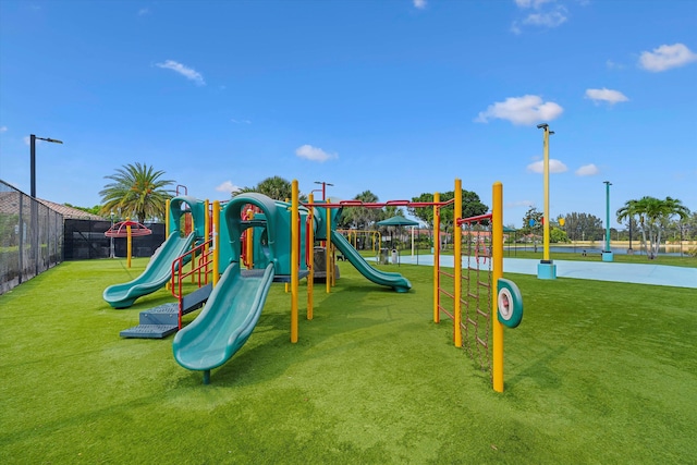 view of jungle gym featuring a lawn