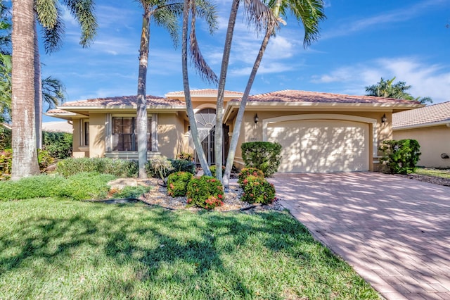 view of front of house featuring a garage and a front yard