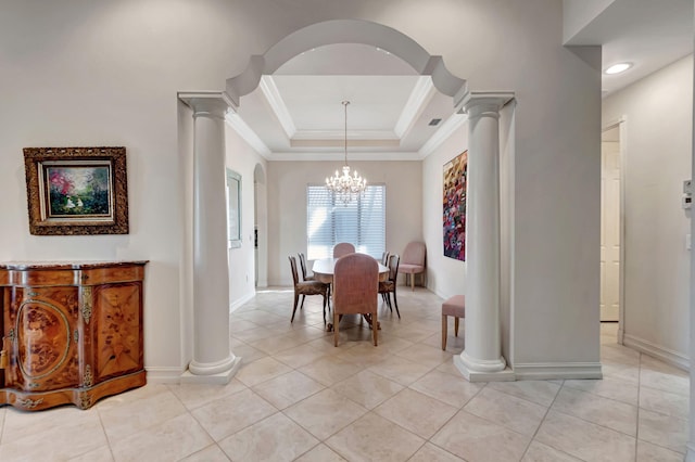 dining room featuring light tile patterned flooring, crown molding, a tray ceiling, and a chandelier