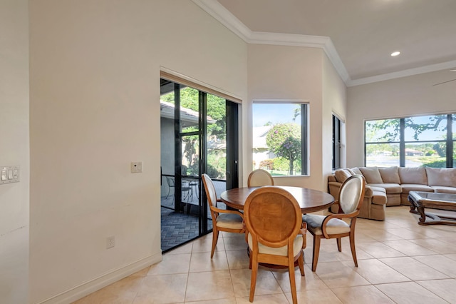 tiled dining area featuring a wealth of natural light and ornamental molding