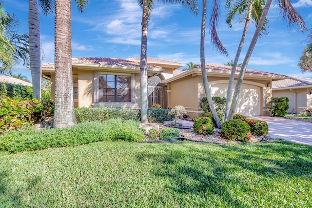 view of front of property featuring a front yard and a garage