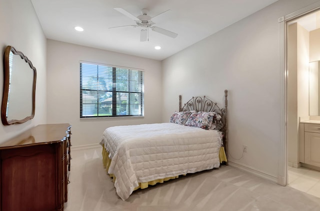 carpeted bedroom with ensuite bath and ceiling fan