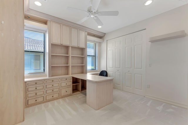 office area featuring light carpet, a wealth of natural light, and ceiling fan