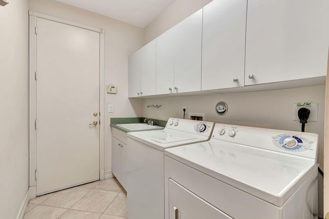 laundry area with washer and dryer, sink, cabinets, and light tile patterned flooring