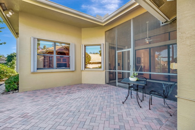 view of patio featuring a sunroom