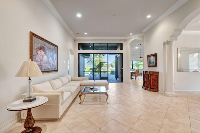 living room with ceiling fan, ornamental molding, and light tile patterned floors