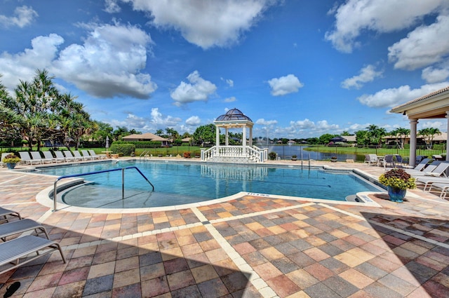 view of pool with a gazebo, a patio, and a water view