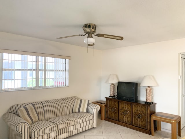 living room with ceiling fan and light tile patterned floors