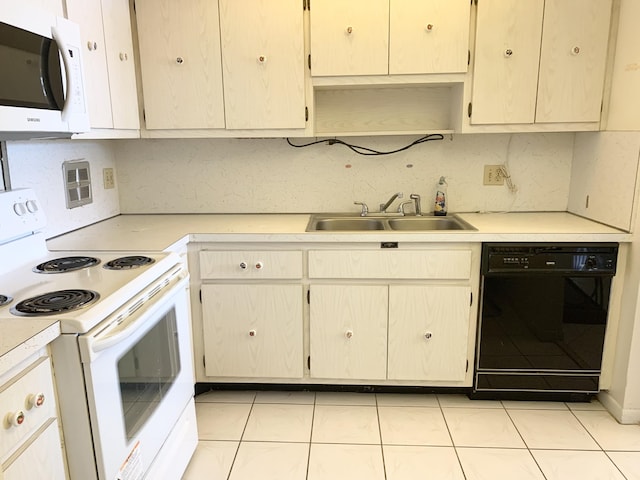 kitchen featuring white appliances, sink, and light tile patterned floors