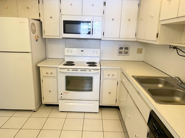 kitchen with light tile patterned flooring, white appliances, and sink