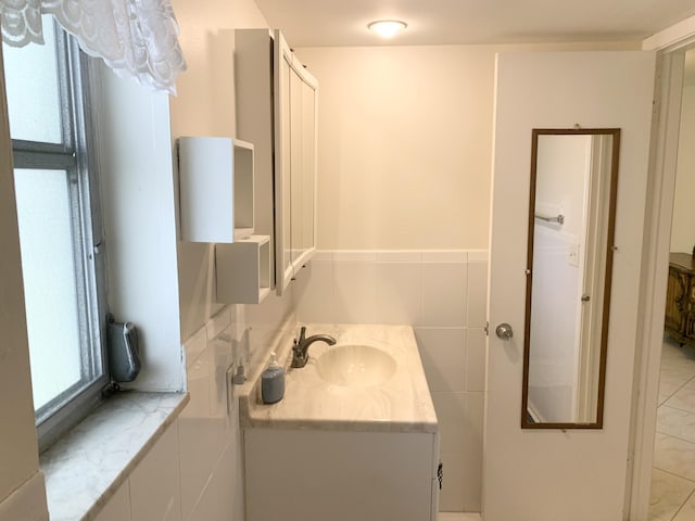 bathroom featuring tile patterned flooring and vanity