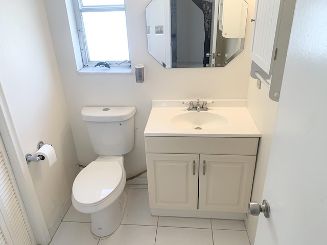 bathroom featuring toilet, vanity, and tile patterned floors