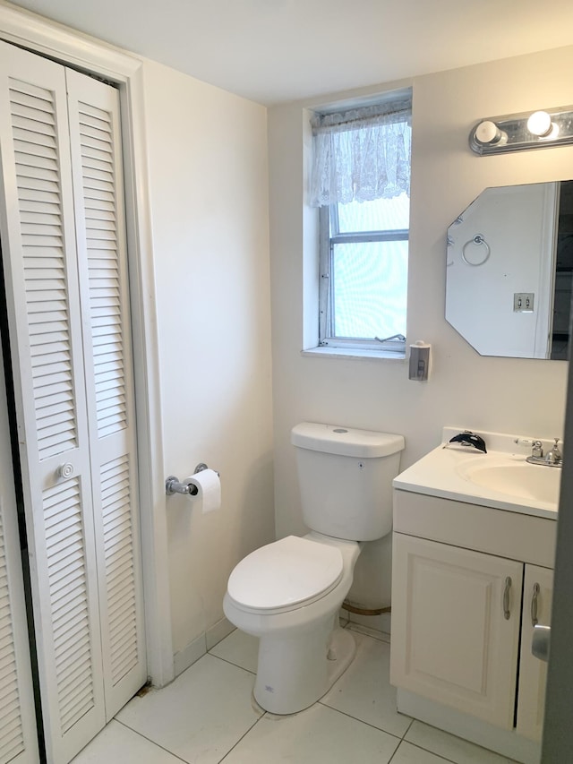 bathroom with tile patterned floors, vanity, and toilet