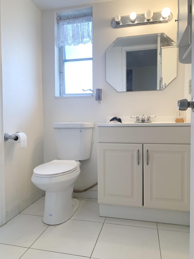 bathroom featuring tile patterned flooring, vanity, and toilet