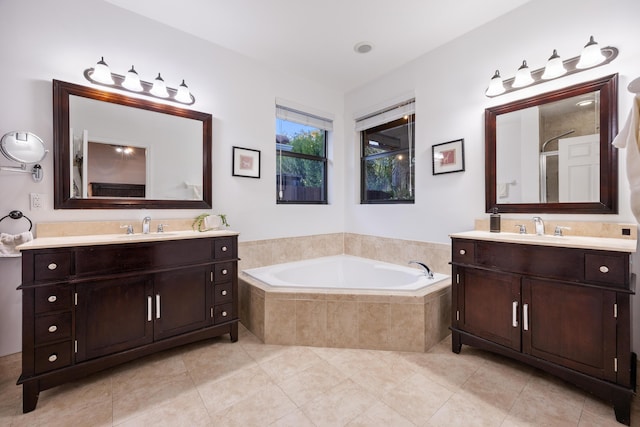 bathroom featuring tile patterned flooring, vanity, and separate shower and tub