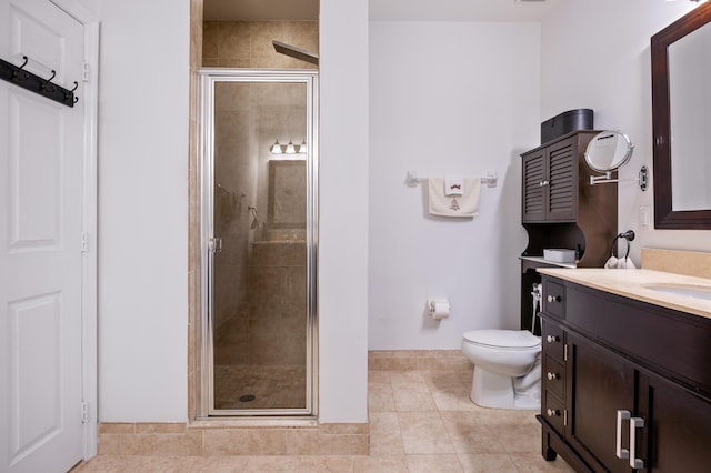 bathroom with vanity, toilet, tile patterned floors, and walk in shower