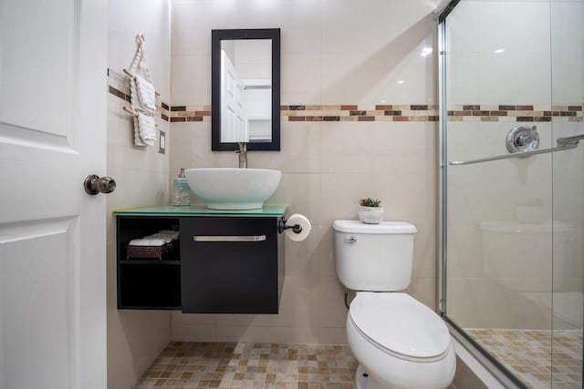 bathroom with vanity, toilet, and a shower with shower door