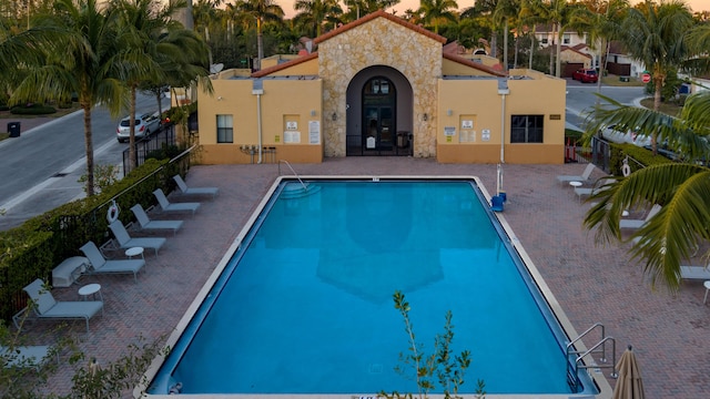 pool at dusk with a patio