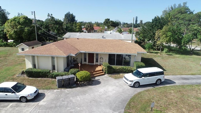 1675 E Breezy Ln, West Palm Beach, FL 33417 - ranch-style house with a porch, roof with shingles, and a front yard