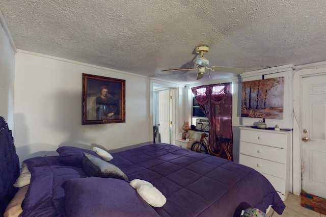 bedroom with ceiling fan and a textured ceiling