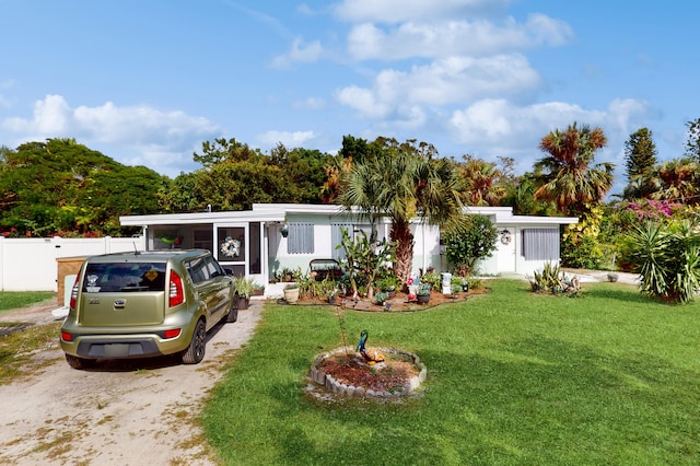 manufactured / mobile home with a front yard and a sunroom