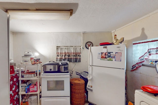 kitchen with washer / clothes dryer and white appliances