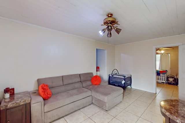 living room featuring light tile patterned floors, ceiling fan, and ornamental molding