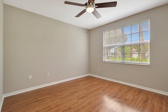 empty room with wood-type flooring and ceiling fan