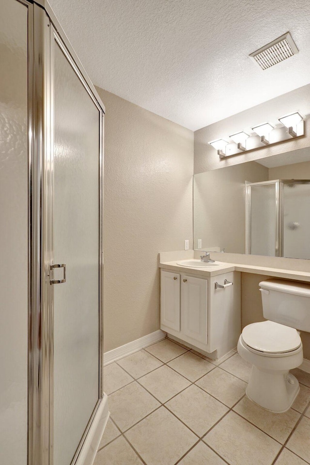 bathroom featuring a textured ceiling, vanity, and tile patterned floors