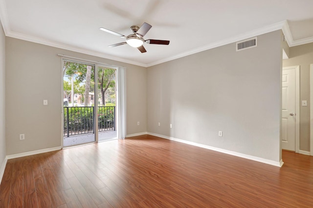 empty room with ceiling fan, crown molding, and hardwood / wood-style flooring