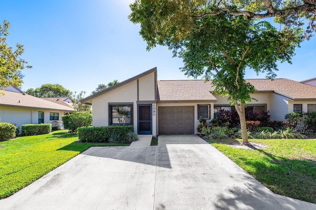 single story home with a garage and a front lawn