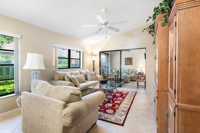 tiled living room featuring ceiling fan, a textured ceiling, and vaulted ceiling