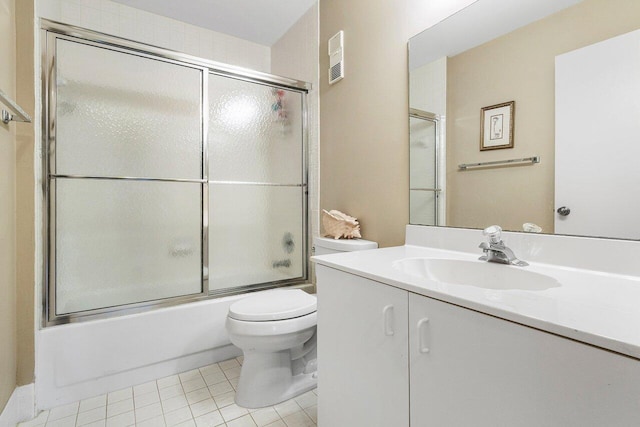 full bathroom with toilet, vanity, tile patterned floors, and enclosed tub / shower combo