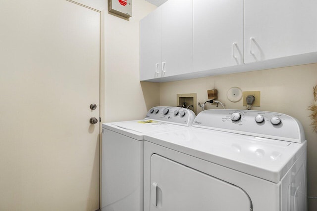 laundry area with cabinets and washing machine and dryer