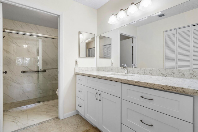 bathroom with walk in shower, vanity, a textured ceiling, and toilet