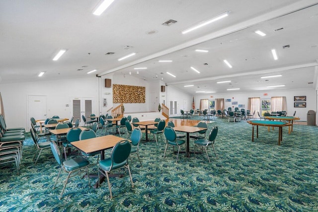 interior space featuring carpet floors, a textured ceiling, and vaulted ceiling